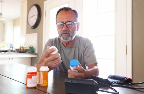 A man looking at his pills for chronic pain.