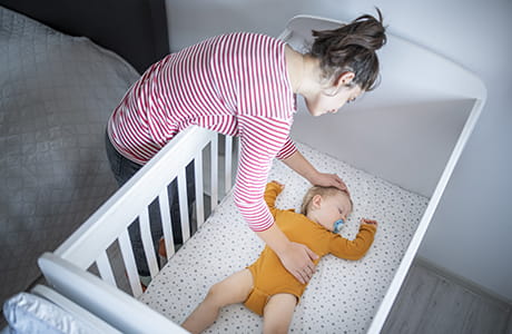 Caring young mother sleep training her baby