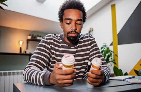 A man reviewing his kidney disease medications. 