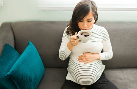 A pregnant woman with a coffee alternative