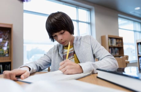 Young boy getting assistance with school work