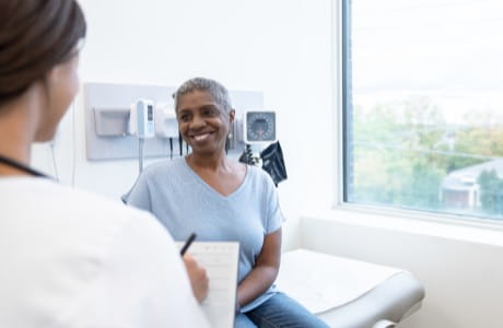 Female patient discussing osteoarthritis treatment with her doctor