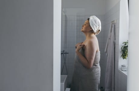 A women looking in the mirror checking her breast