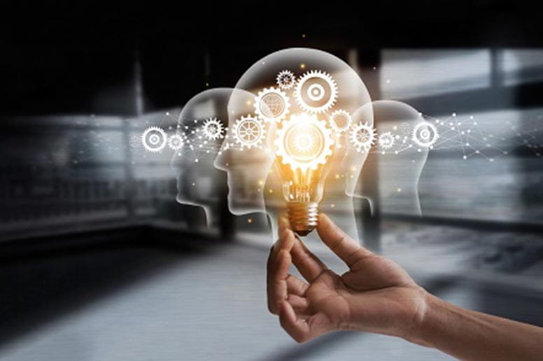 A hand holding a lightbulb