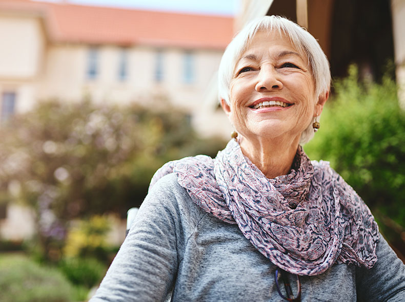 A woman outside smiling