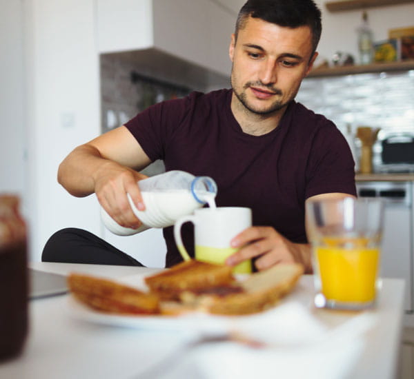 man enjoying breakfast well rested