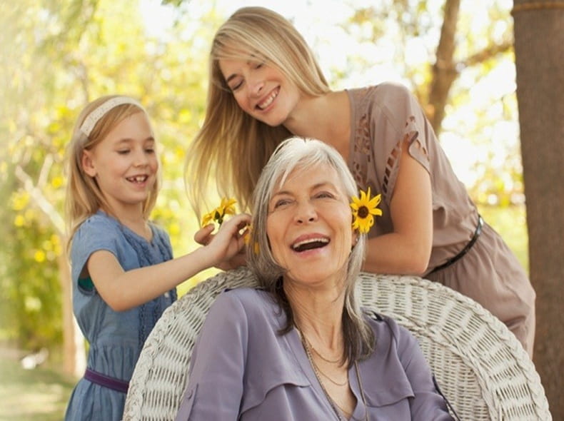 Three generations of women playing outdoors