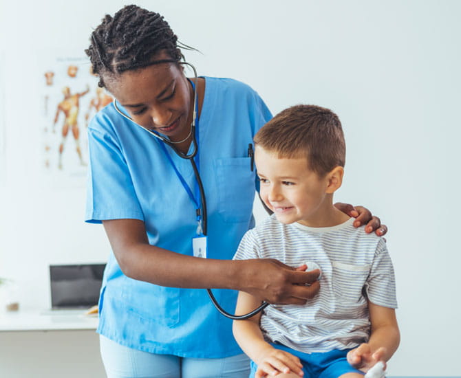 A boy having his heart checked by his doctor