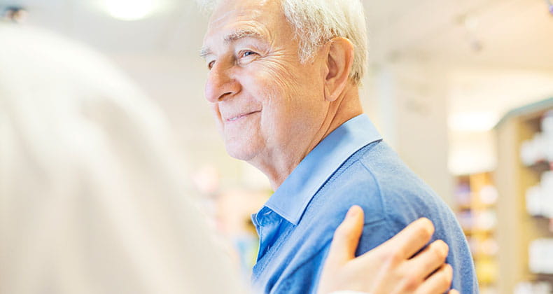 A man engaging with his pharmacist