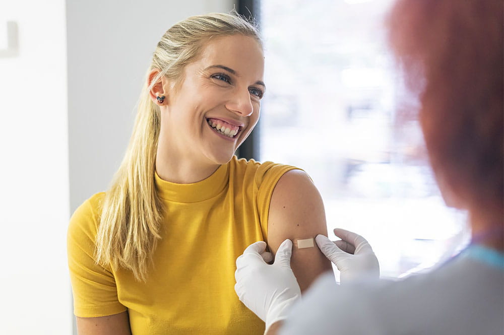 atient receiving a seasonal flu vaccine from a healthcare professional during an influenza vaccination appointment.