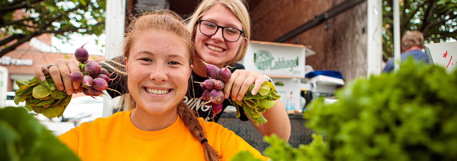 females holding vegetables