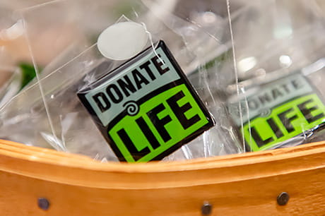 Donate Life pins rest within a woven basket.