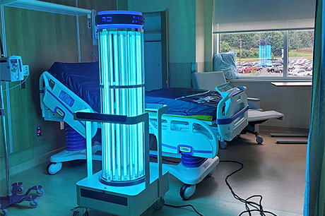 A UV disinfection device being used in a patient room.
