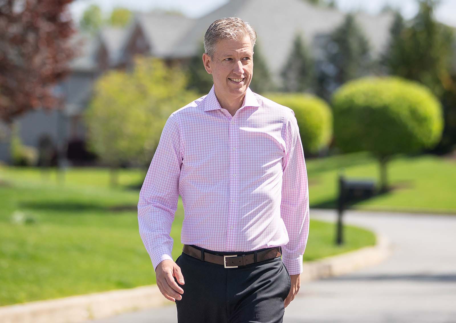 Community member walking outdoors in a neighborhood setting, representing healthy lifestyle and recovery journey support.