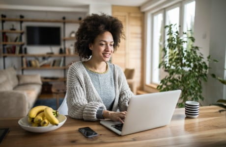 a woman looking at a laptop
