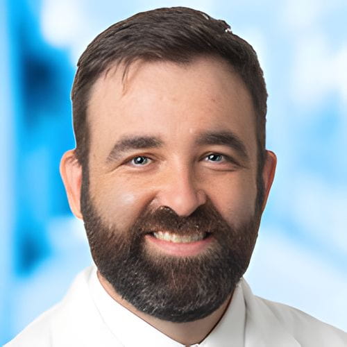 Headshot of Dr Garmon on white and blue background