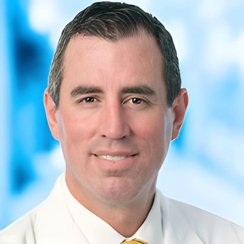 Headshot of Dr Young on white and blue background