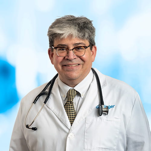 Headshot of Dr DeMatteo on white and blue background