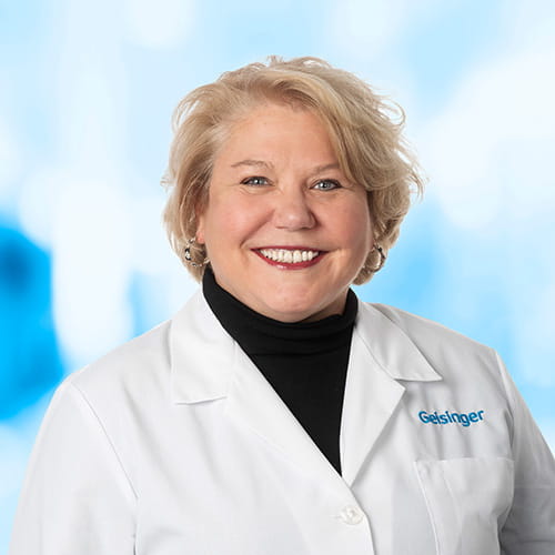 Headshot of Dr Goodrich on white and blue background