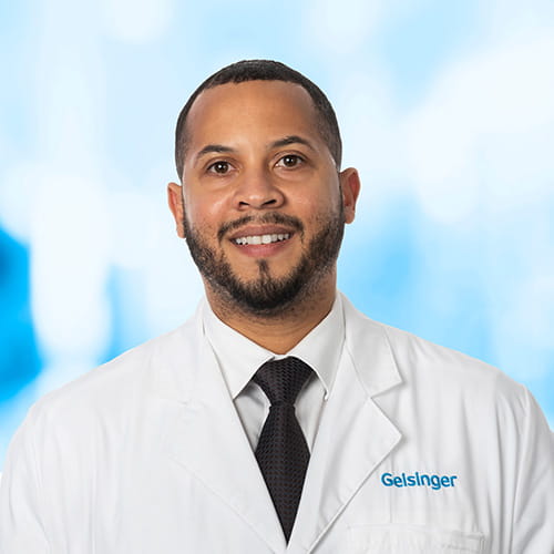 Headshot of Dr Heath on white and blue background