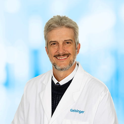 Headshot of Dr Hood on white and blue background