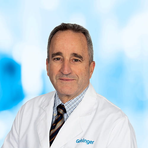 Headshot of Dr Mannino on white and blue background