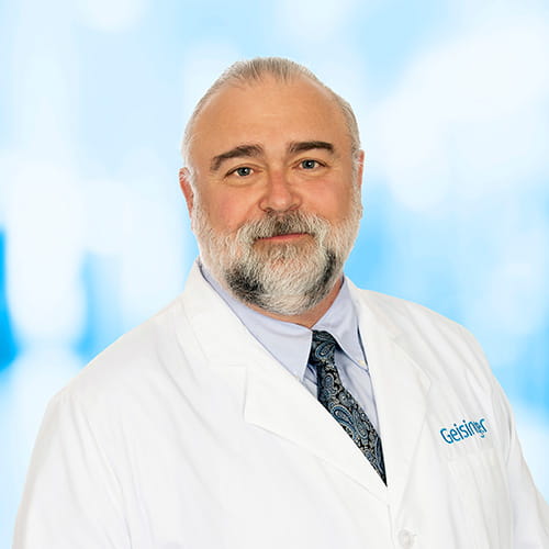 Headshot of Dr Smith on white and blue background