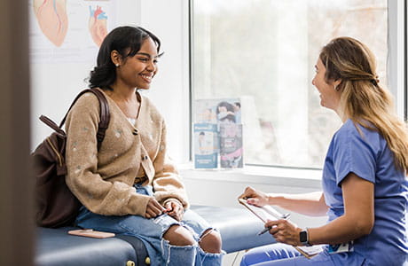 A young patient talking to their primary care doctor